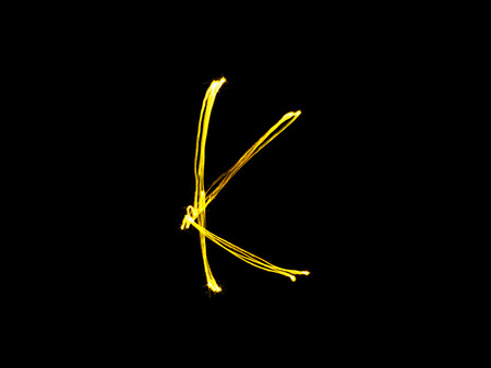 Sparkler firework light alphabet K (Capital Letters) at night backgroundの写真素材