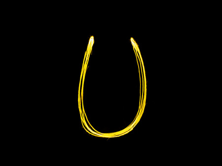 Sparkler firework light alphabet U (Capital Letters) at night backgroundの写真素材