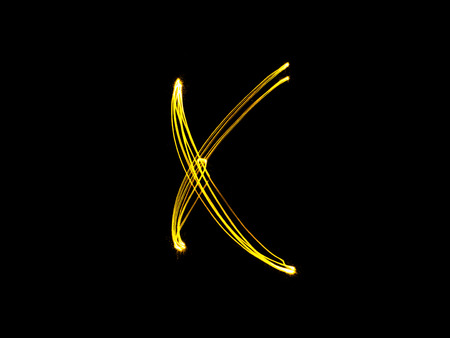 Sparkler firework light alphabet X (Capital Letters) at night backgroundの写真素材