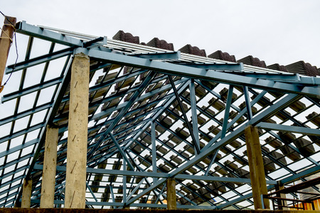 worker installing structure of roof steel,roof-tile  for new building at construction site, thailand...