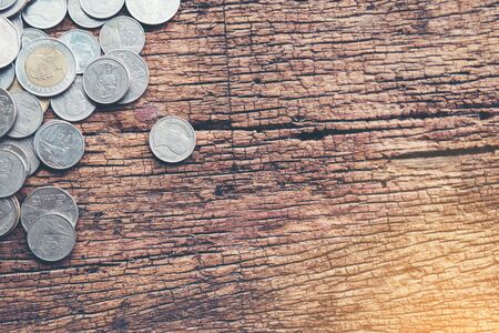 money and coins on wood vintage backgroundの写真素材