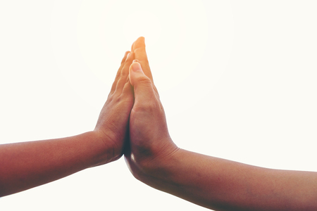 Two hands together, Close up of mother or older sister and a child hands Friendship and love concept with copy space white backgroundの写真素材
