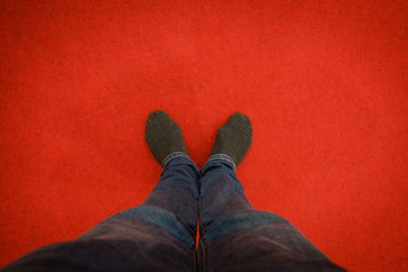 black sock standing on red carpet floorの写真素材