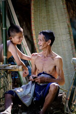 Thailand Father and son are working hand made Basket bamboo or fishing gear. Local life country Thailandの写真素材