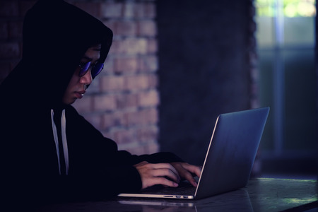 Hacker working on his computer, Hacker stealing password and data from laptop, identity theft and...