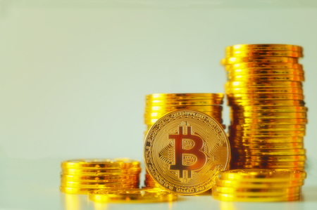 Stack of glod bitcoins with a single coin facing the camera in B sharp focus, Cryptocurrency concept. Virtual currency digital payment systemの写真素材