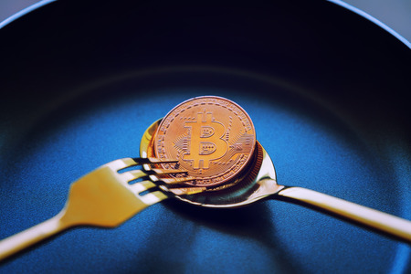 Everyone wants bitcoin, Digital currency physical gold bitcoins on dish, Crytocurrency Coin under the forkand spoon, Blockchain Transaction System Crisis Conceptの写真素材