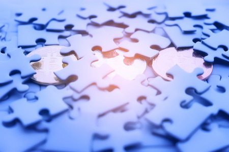 Three Gold bitcoin on white jigsaw or puzzle, cryptocurrency. Missing jigsaw puzzle pieces. Business concept. Completing final task dreamの写真素材