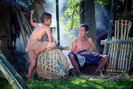 Thailand Father and son are working hand made Basket bamboo or fishing gear. Local life country Thailandの写真素材