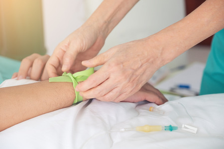 A rubber tourniquet binding the arm tight preparing for blood drawn for laboratory examination...