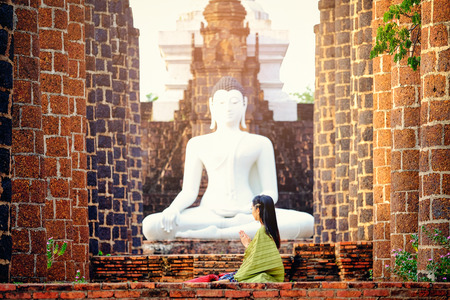 Beautiful Thai girl in traditional dress costume at Thai temple where is the public placeの写真素材