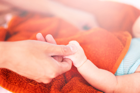 Father holding newborn baby hand. Happy Family concept. Beautiful conceptual image of Maternity, Newborn baby boy handの写真素材