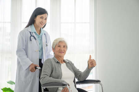 Health visitor and a senior woman during home visit.の写真素材