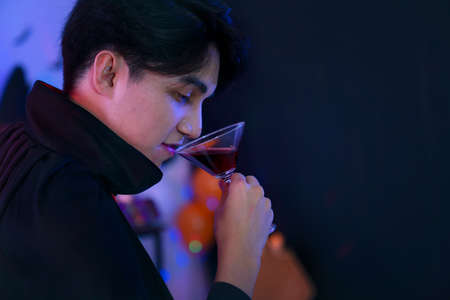 Young man in Costumes Celebrating Halloween having Fun at Party in Nightclub by doing Scary faces.の写真素材