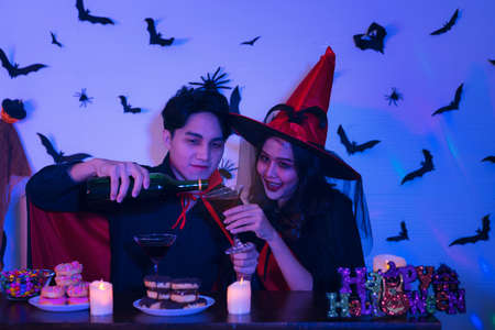 Young Thai People in Costumes Celebrating Halloween. Group of Young Happy Friends Wearing Halloween Costumes having Fun at Party in Nightclub by doing Scary faces.の写真素材