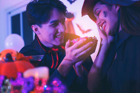 Young Thai People in Costumes Celebrating Halloween. Group of Young Happy Friends Wearing Halloween Costumes having Fun at Party in Nightclub by doing Scary faces.の写真素材