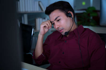 Thai asian call center business people get headache and migraine from working late night shift for...