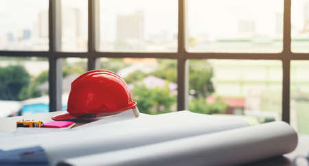 safety helmet and the blueprint at construction site