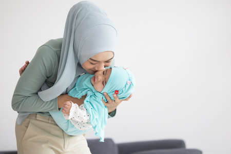 Happy muslim mother holding a beautiful little babyの写真素材