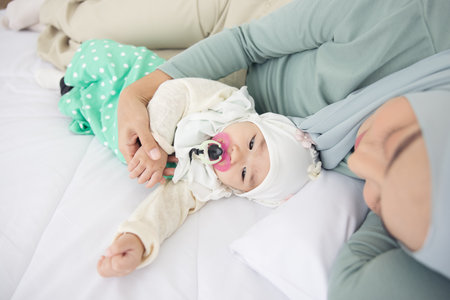Baby And Mother At Home In Bed, Happy loving family