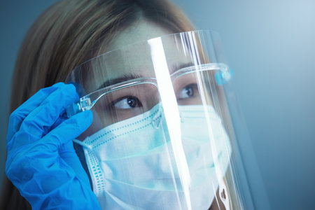 closeup female health care worker wearing headband and protective equipmentの写真素材