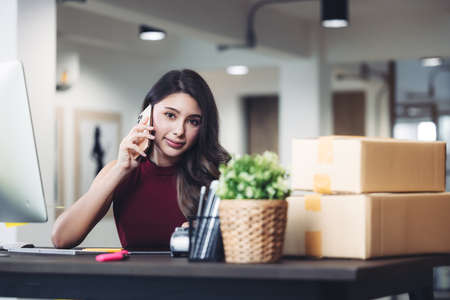 Woman Working At Home With Laptop And Mobile Phone