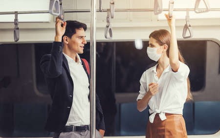 People on the train wear anti-virus masks and travel during rush hours. passengers inside the Sky Train with the masks on all people's faces.の写真素材