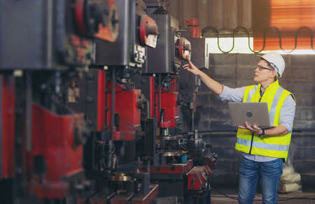 engineer man, or technicians wearing surgical mask and using computer notebook for Checkingの写真素材