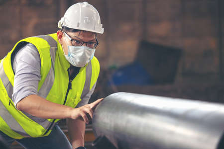 Engineers examine new coated pipe in factory, Ventory Check