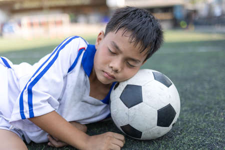 Cute little child dreams of becoming a soccer player. sport and activity conceptの写真素材