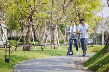 Couple workout and exercise with scooter together outdoor in park