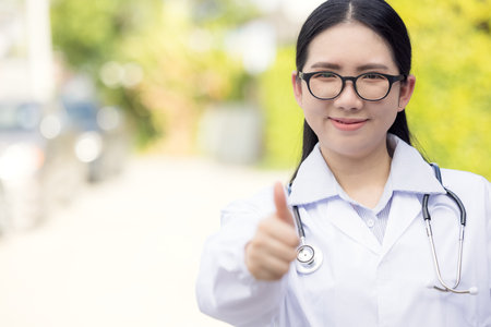 Portrait Of Female Doctor Standing Outside Hospitalの写真素材
