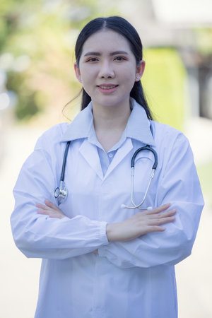 Portrait Of Female Doctor Standing Outside Hospitalの写真素材