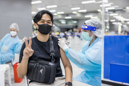 BANGKOK, THAILAND - 21 Jun 2021: Thai Health Officer Mobilize VACCINATION COVID-19 for commuters in charge of public transit services at Bang Sue Grand Station. man ready for Sinovac vaccinesのeditorial素材