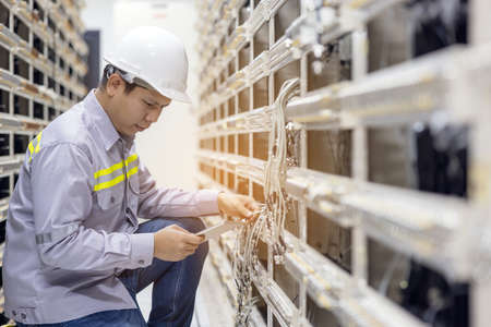 Network engineer working with tablet  in server data center room, professional skilled technicianの写真素材