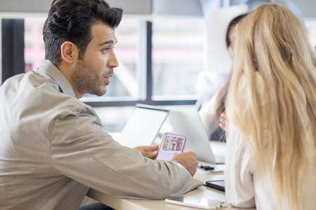 Group of people using and looking at mobile phone,  Business project team working together at...