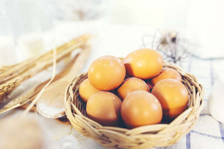 basket of fresh eggs on wooden table for making bakeryの写真素材