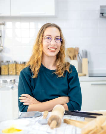 portrait Beautiful Woman With tools made Baked Breads in kitchenの写真素材