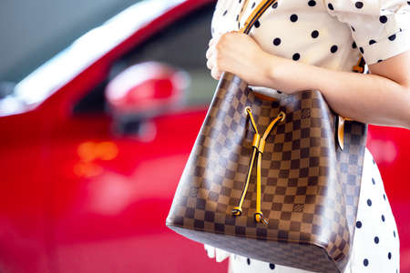 July 26, 2021: Nakhon Prathom, THAILAND, A woman carrying a Louis Vuitton square bag. Louis Vuitton...