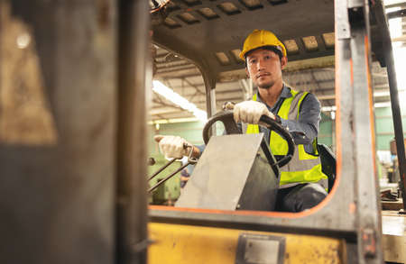 Engineer Man forklift driver with a background in an industrial or warehousing factory.の写真素材