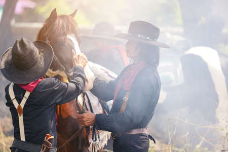 On the countryside, a cowboy walks his horse. Nature notion of freedom.の写真素材