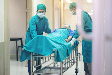 Doctor Getting their patient ready for the next procedure In the corridor, a medical team is pushing...