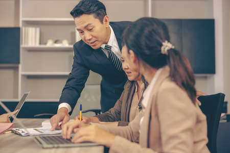 The boss is blaming a young female employee for a job mistake.
An argument between three businesspeople On a meeting in the office, a furious boss shouts at his team.の写真素材