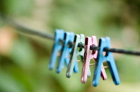 Clothes line and clothespin on a multi-colored background blur.の写真素材