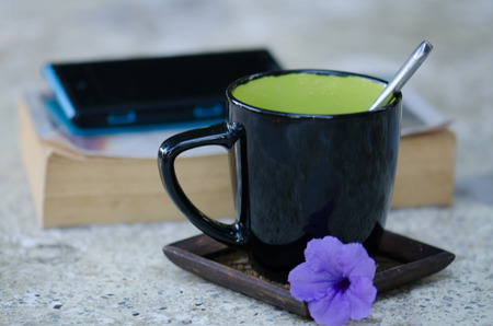 Morning coffee and phone books Put on the table, the sun warm the morning happy.の写真素材