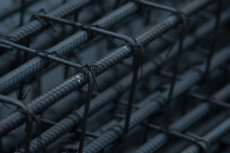 Bending rebar cut and tied together to make a post house. And construction.の写真素材