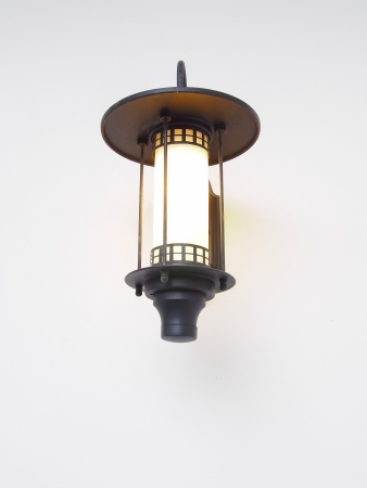 Aged gilded street lamp over whith backgroundの写真素材