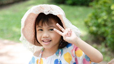 Portrait of happy charming 4 years old cute baby Asian girl, little preschooler child smiling...