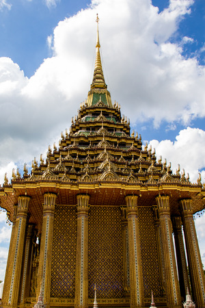 The great ancient golden statue in the light blue sky view at Thailand.の写真素材