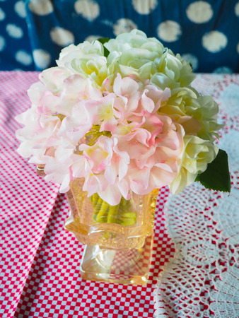Pink and white flowers on the table.の写真素材